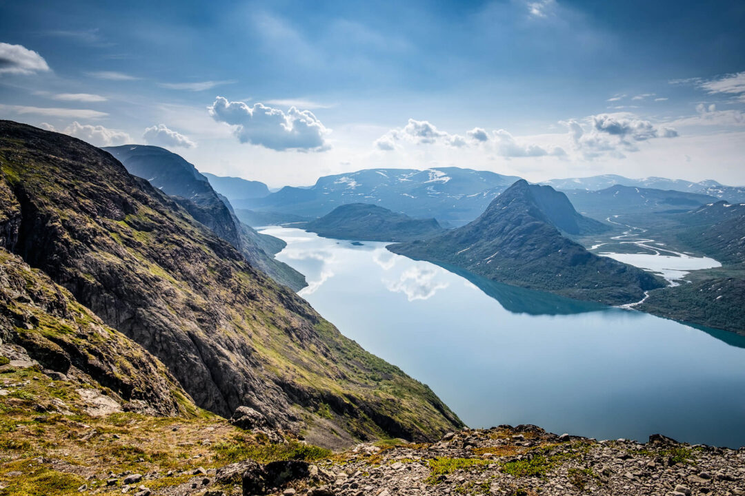 View from Besseggen ridge over Gjende lake and Norwegian mountains in calm summer haze