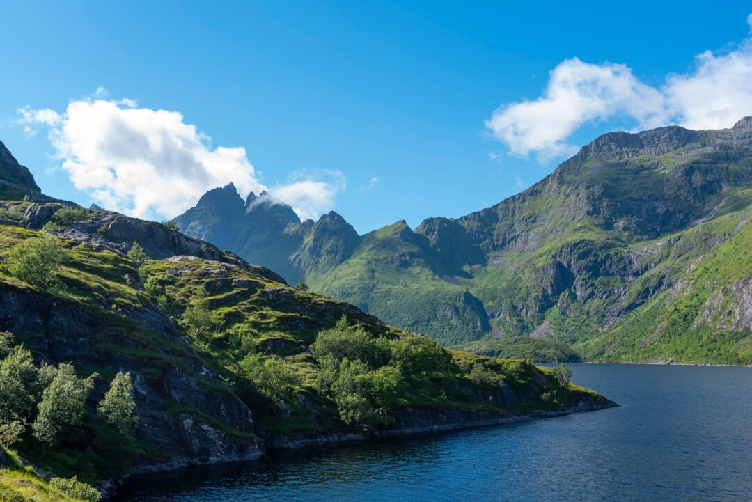 Norwegian fjord landscape with green mountains and hiking scenery in summer