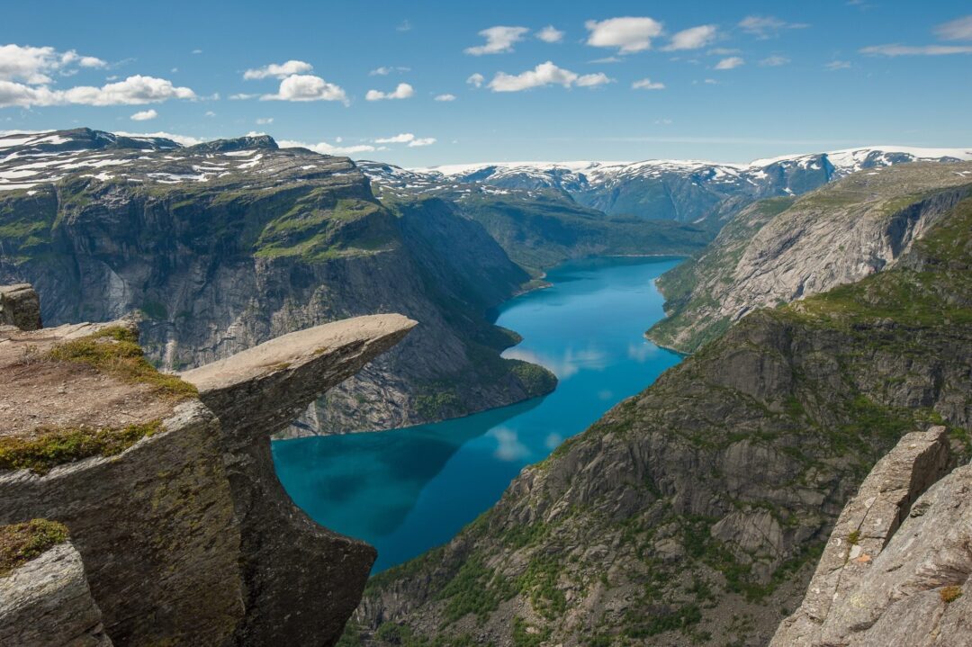 Mountain viewpoint over a turquoise fjord in Norway’s national park landscape, hike route scenery
