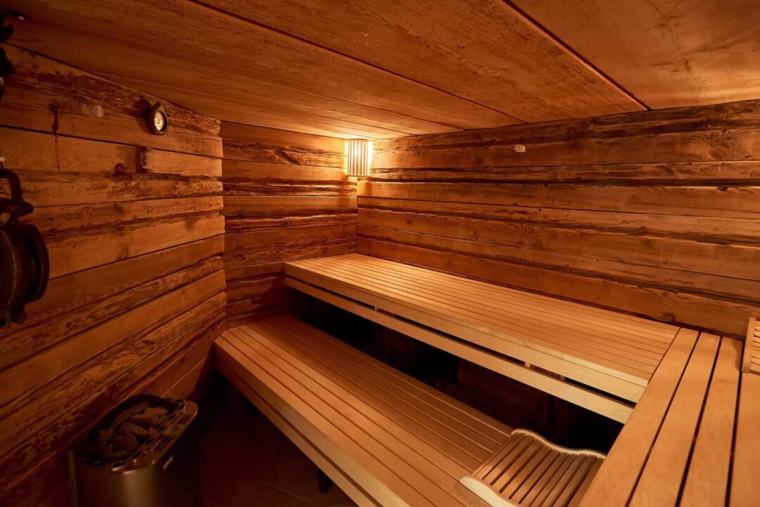 Traditional Finnish sauna interior with wooden benches and warm light, relaxing in the wilderness cabin