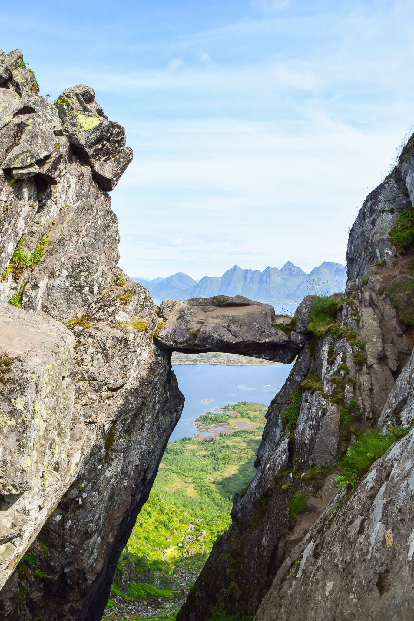 Rocky gorge overlooking a fjord and mountains in Lofoten