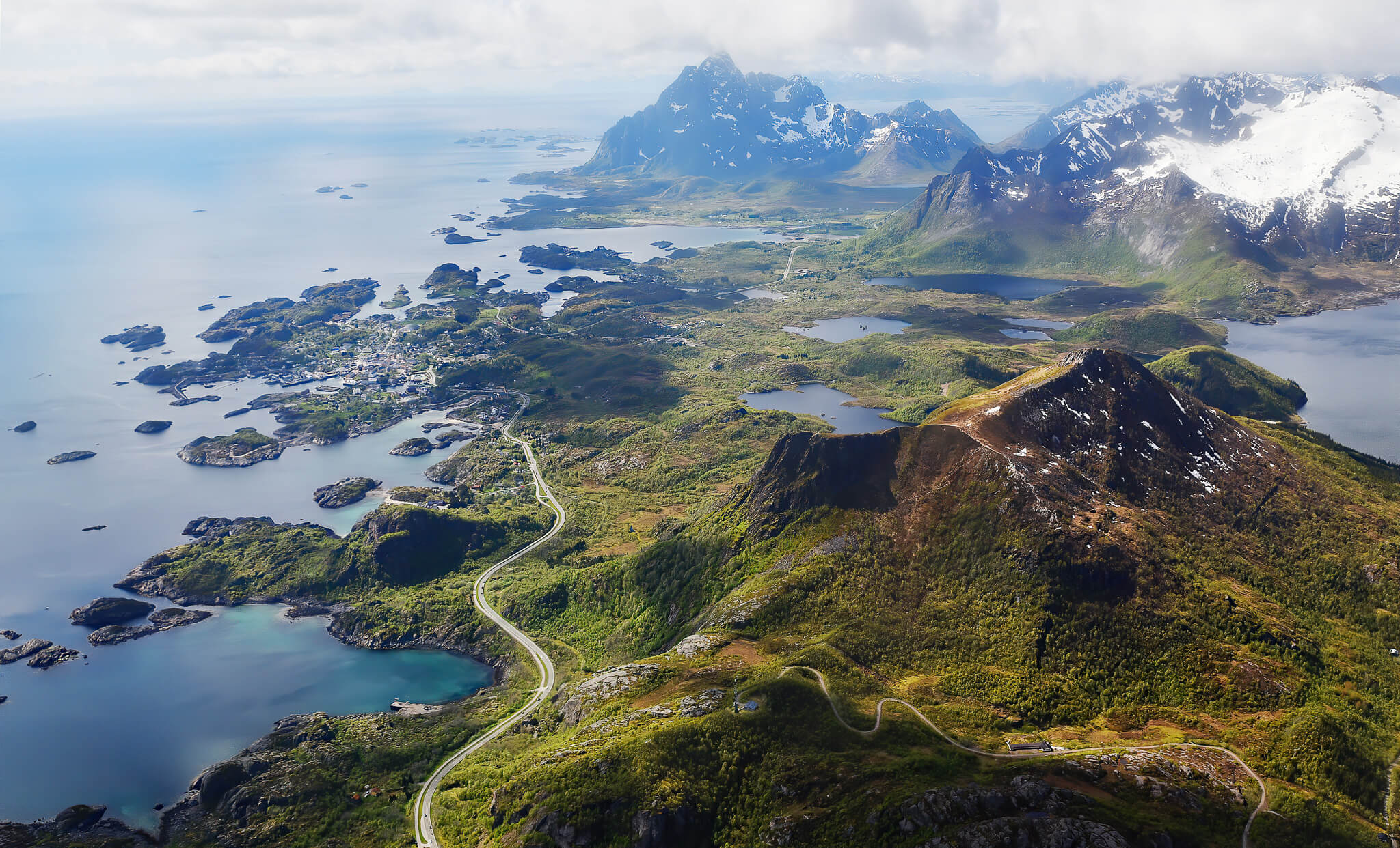 Aerial view of Lofoten fjords and mountains with winding roads and coastline
