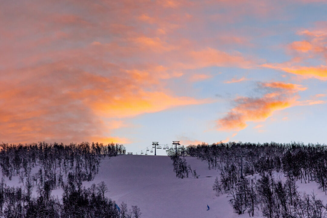 Snowy downhill ski run with ski lift at dusk in Sweden, ideal for beginner downhill skiing holidays