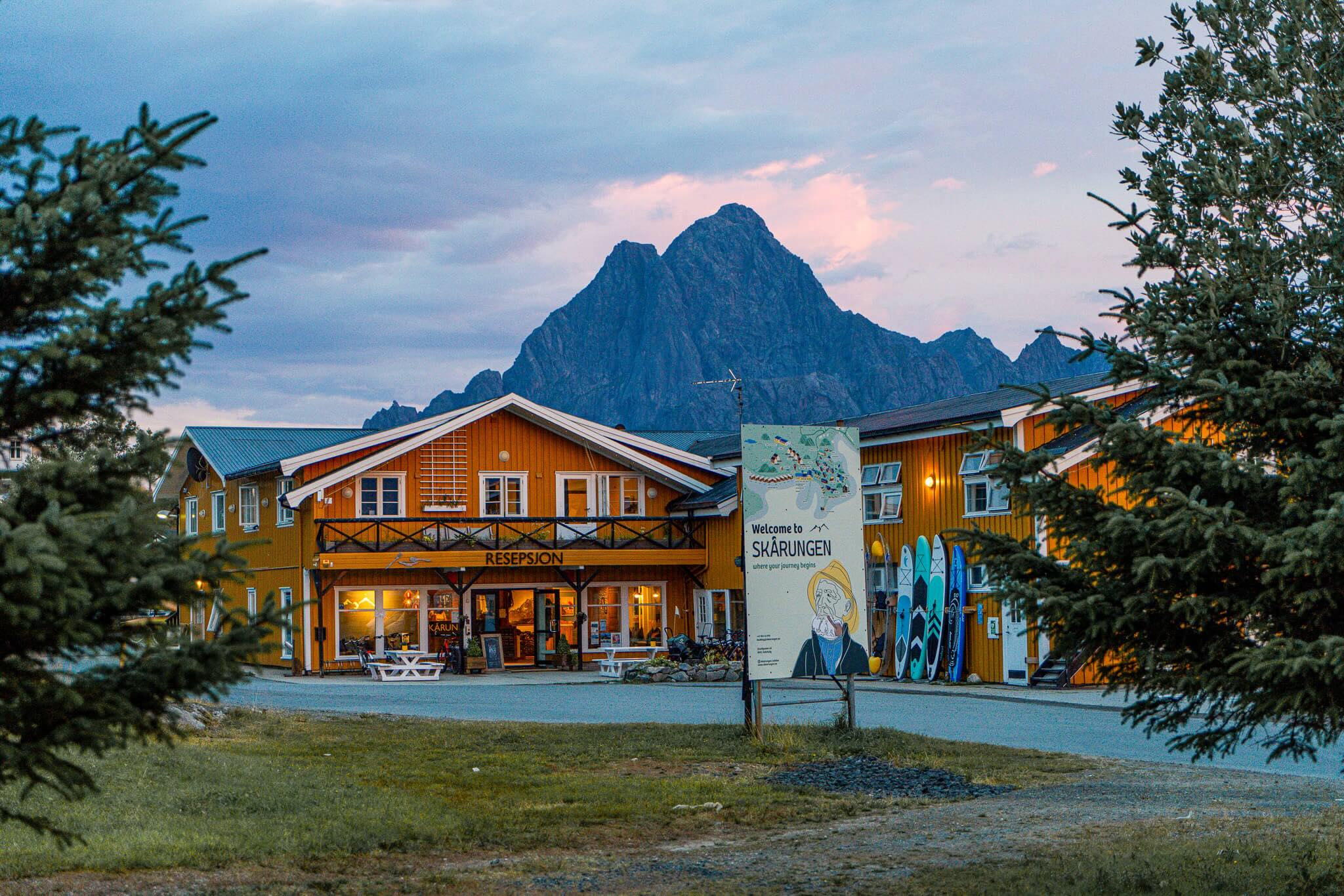 Reception building in Lofoten with “RECEPTION” sign and mountain view at dusk