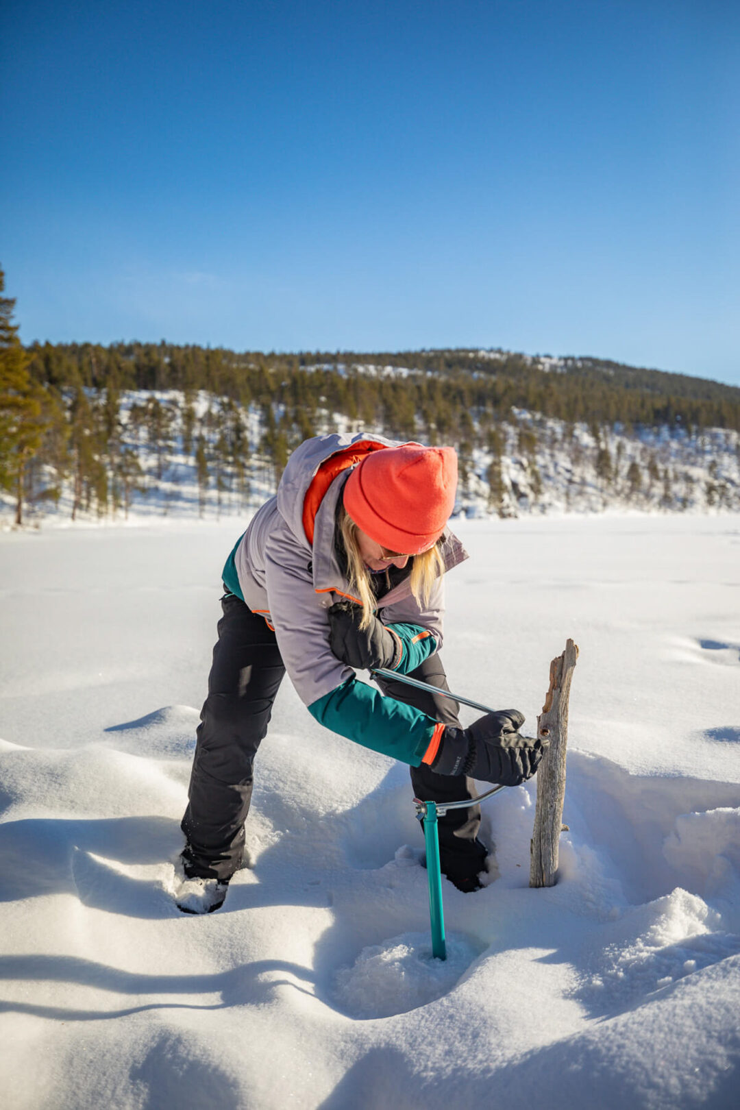 Hut-to-hut backcountry skiing in Lapland, woman snowkiting with a husky dog across the tundra