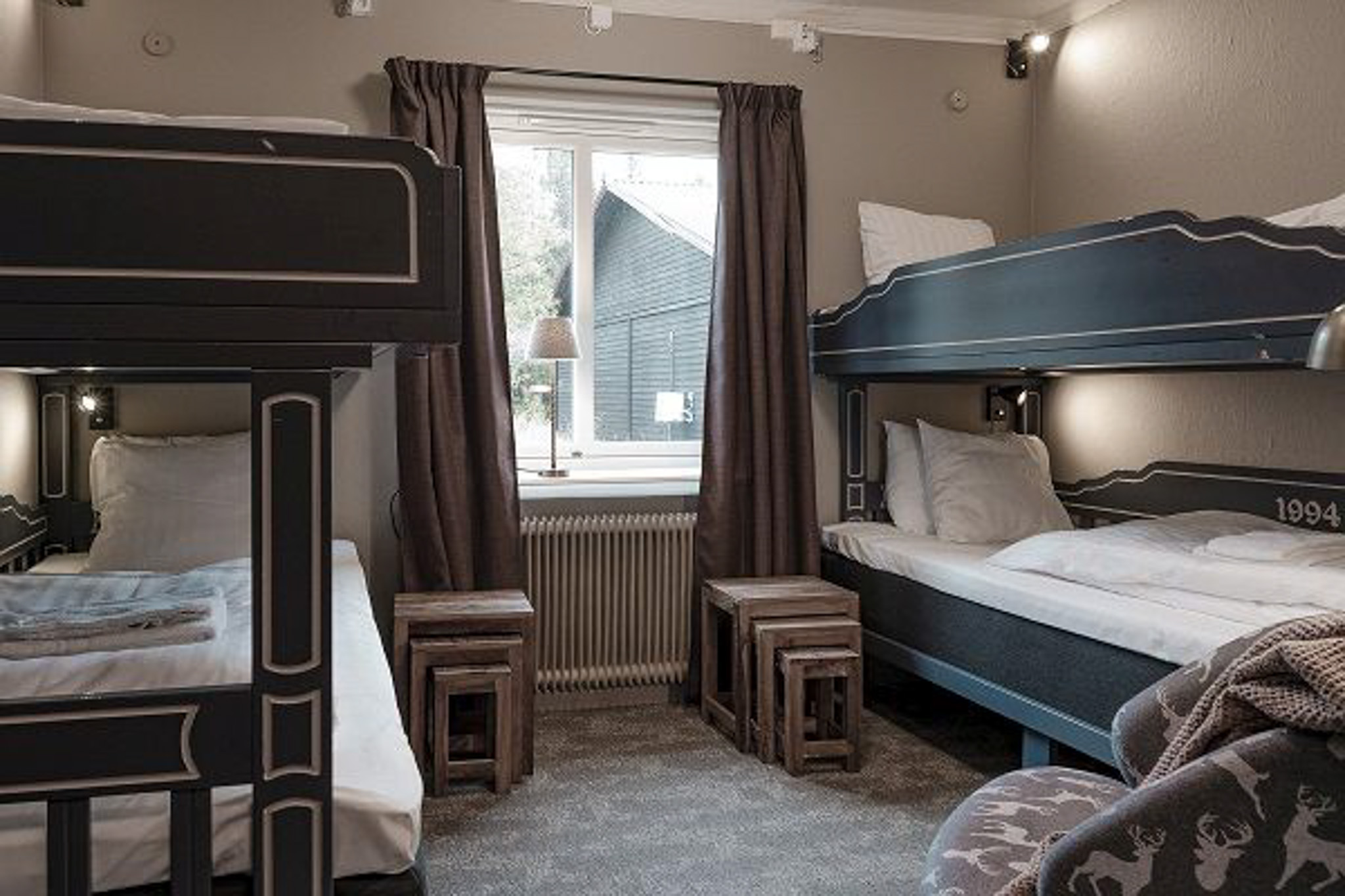 Ski holiday accommodation room with bunk beds and window light, suited for beginners in Sweden