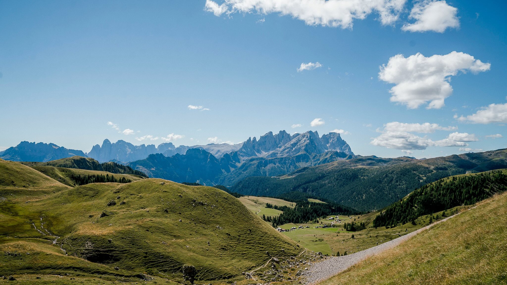 vast view of dolomite mountains and rolling hills