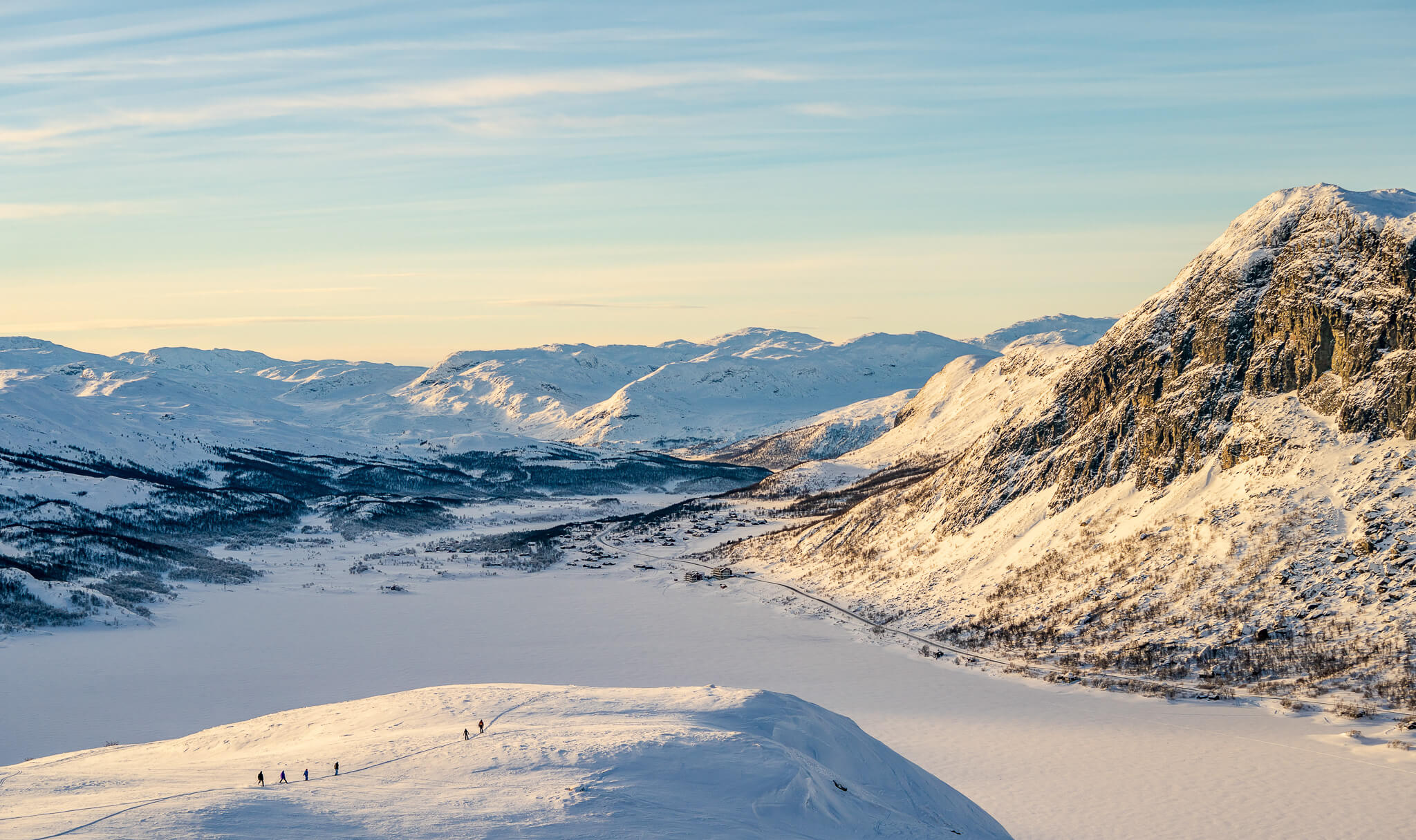 Snow-covered Norwegian mountains with cross-country ski tracks and a winter valley view