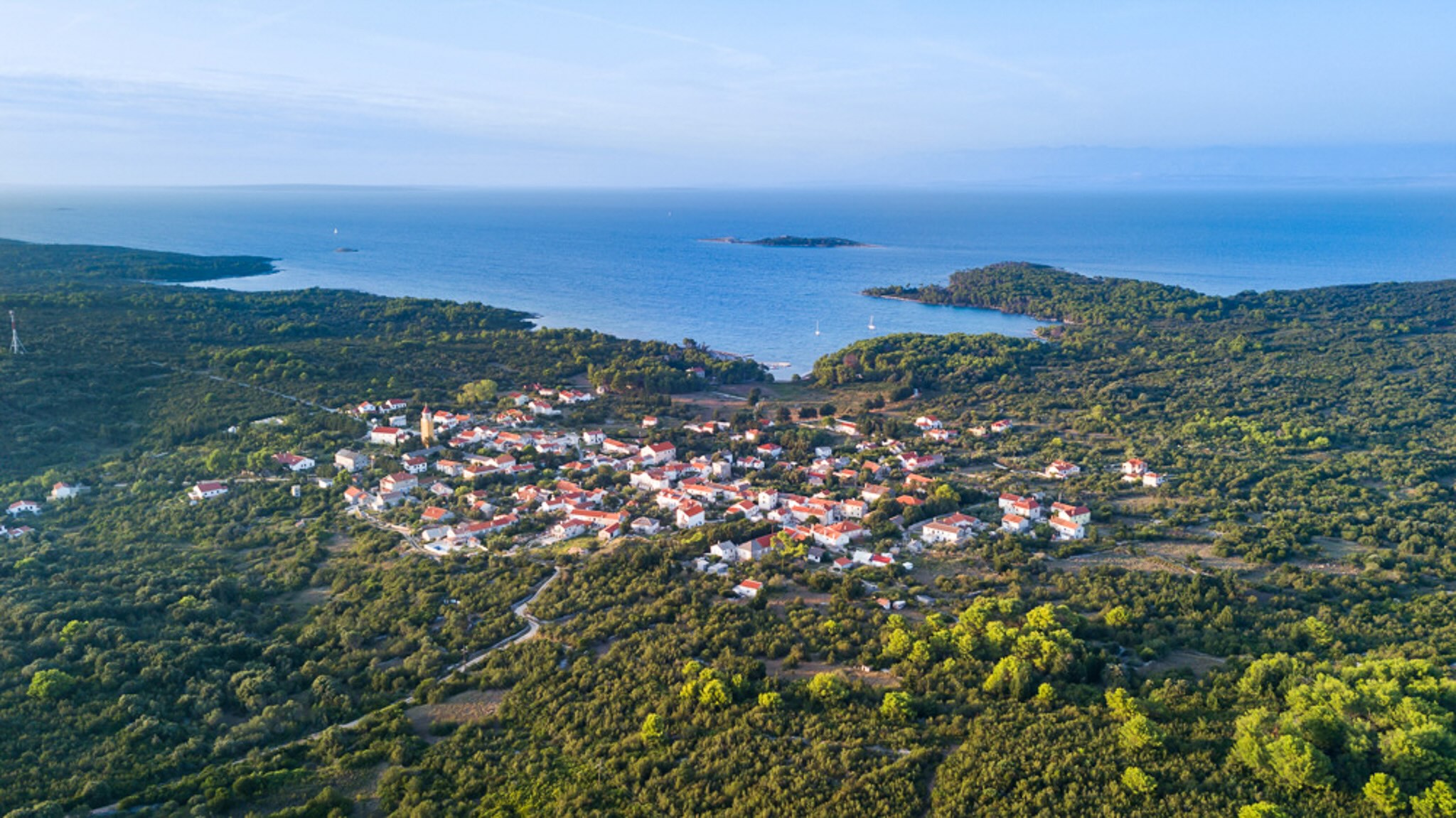 Aerial view of a coastal village and islands in Croatia, surrounded by the Adriatic Sea