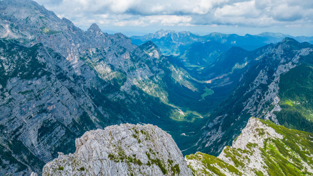 Scenic view over a mountain valley from a rocky ridge, ideal for hiking