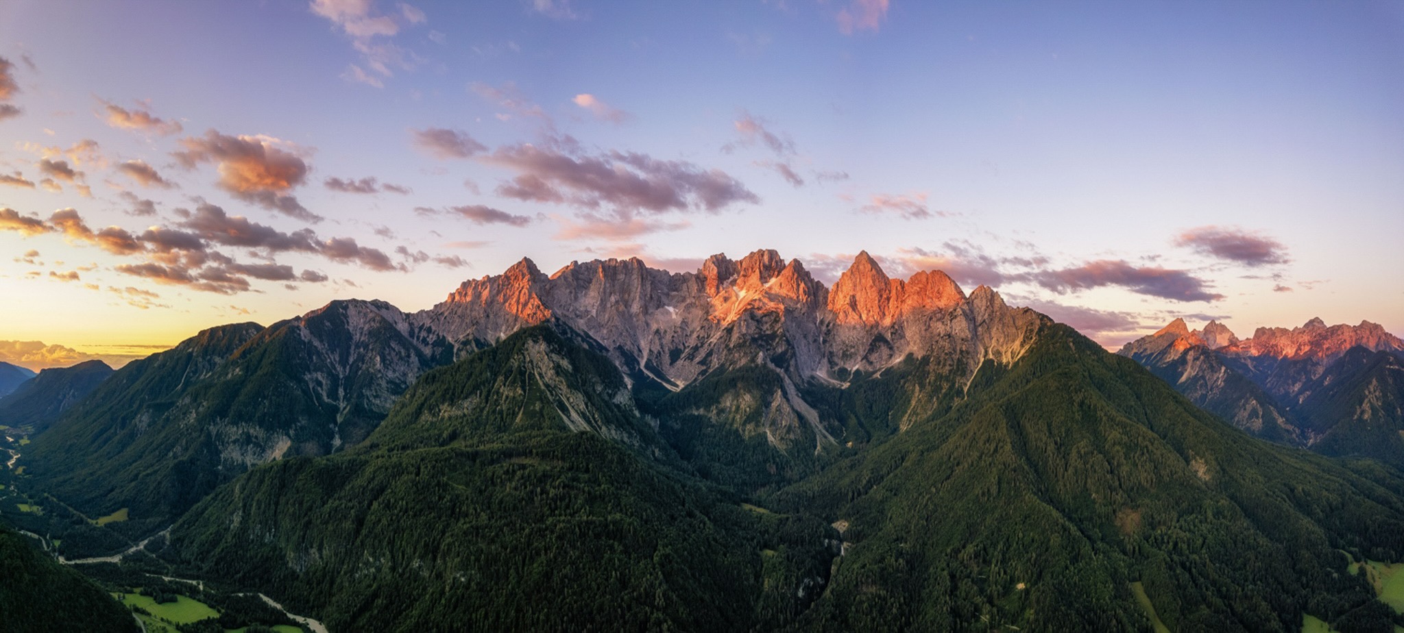 Mountain range at sunset in Slovenia, ideal for hut-to-hut hiking adventures