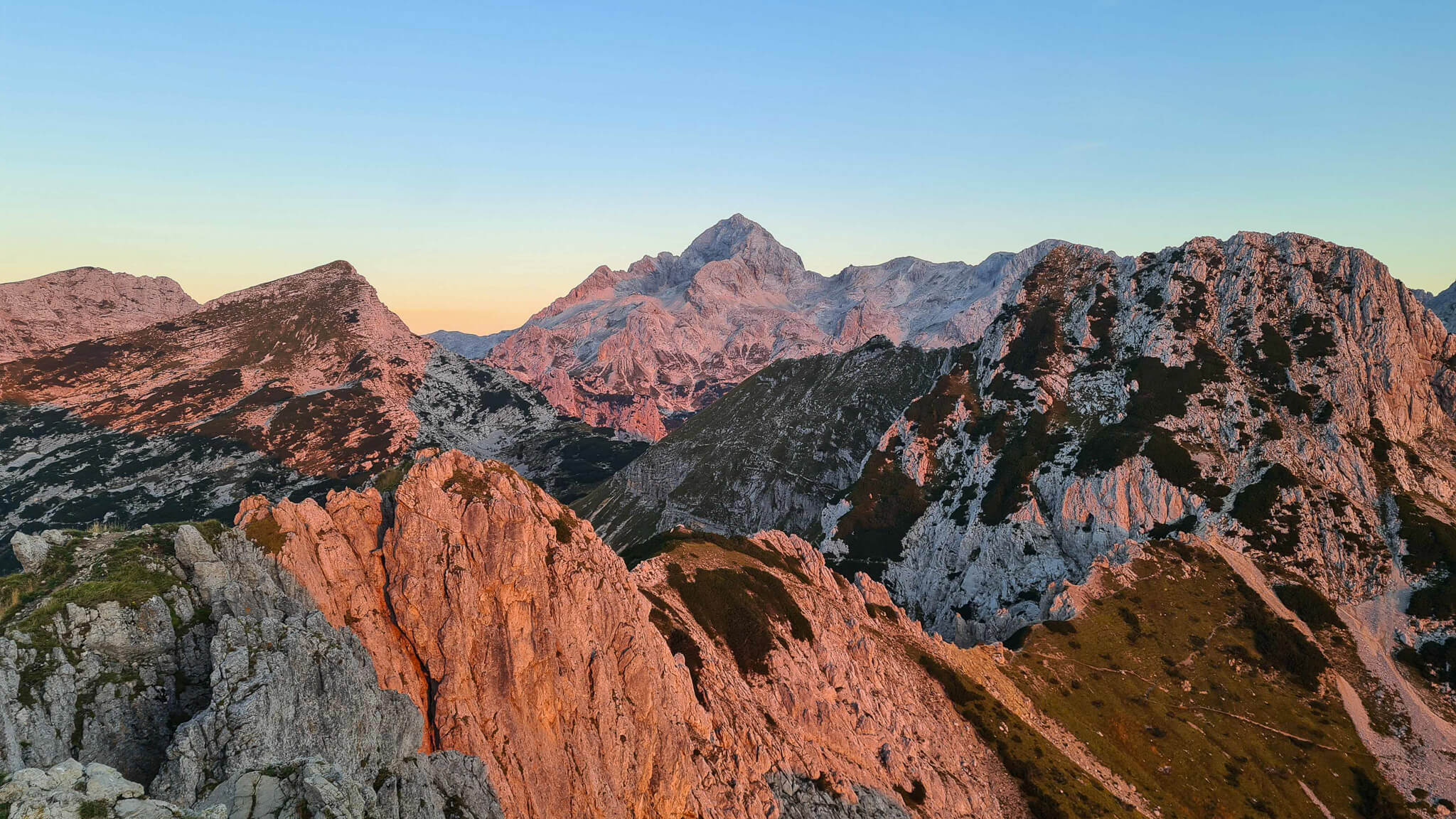 Alpine mountain ridgeline at sunrise, ideal for hut-to-hut hiking