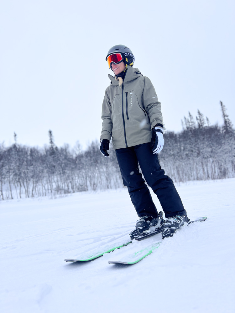 Woman downhill skiing on a snowy slope in winter conditions