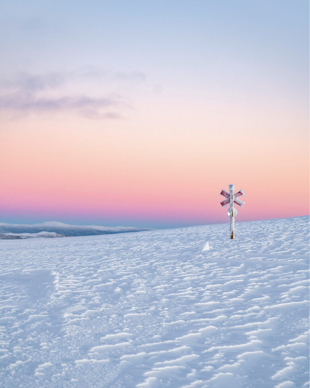 Snowy landscape with a signpost