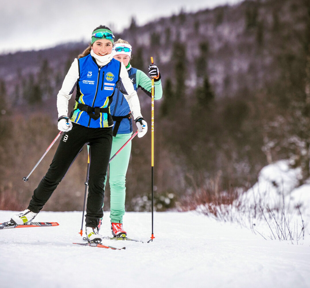 Two women skiers on a snowy trail