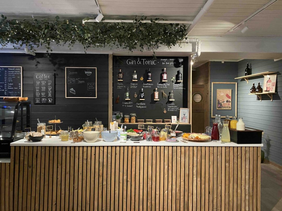 Gin and tonic bar counter with chalkboard menu boards and drinks, indoors at a café
