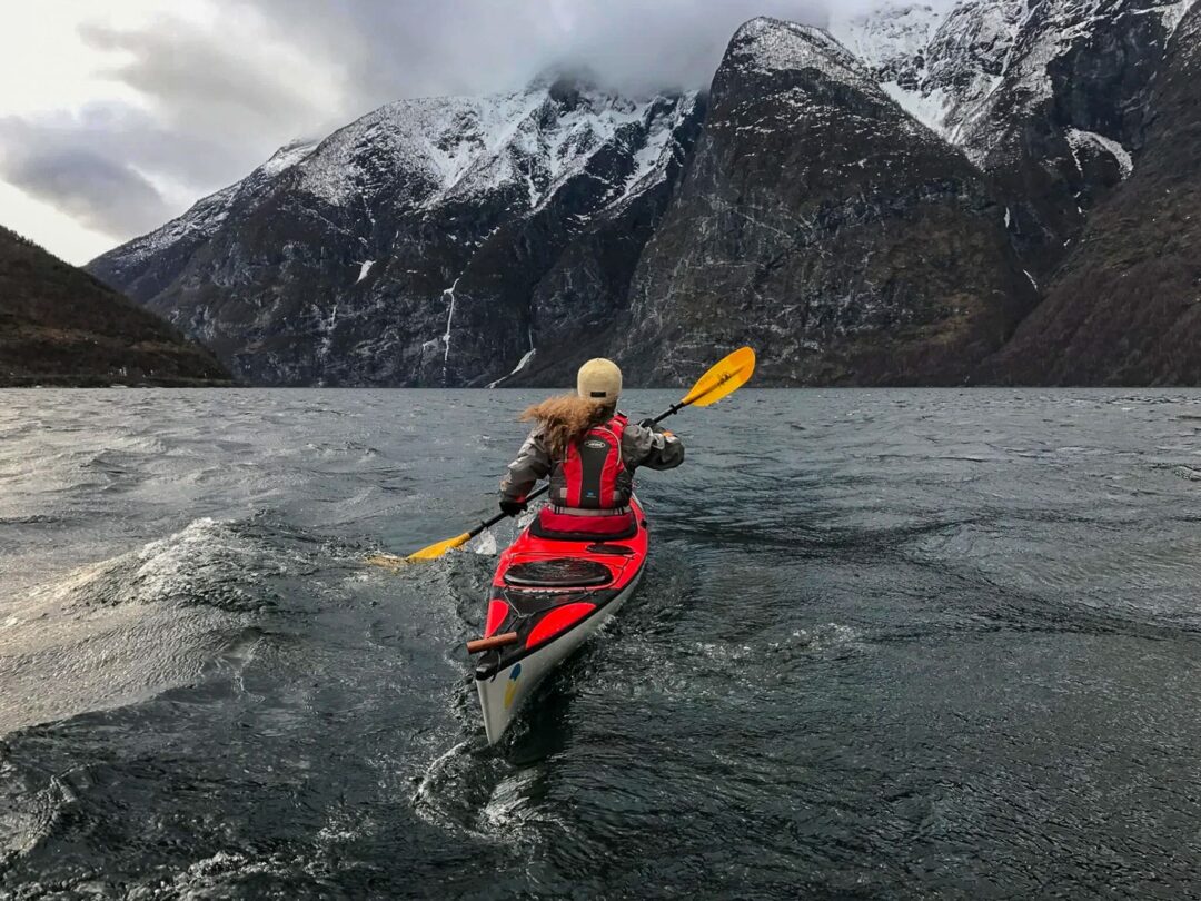 Woman kayaking in mountainous landscape in Norway