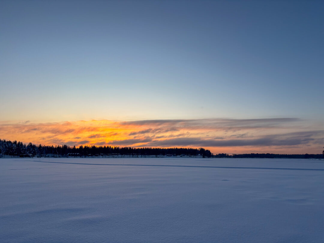 Snowy Finnish landscape at dusk, suitable for cross-country skiing in Finland