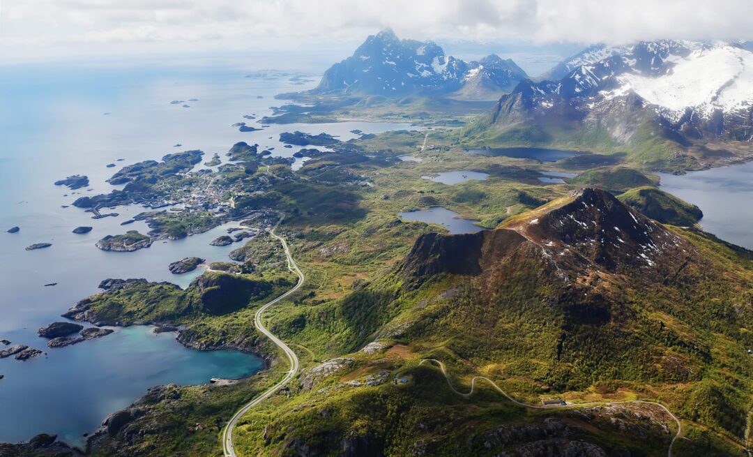 Kayaking SUP, hike and bike route over Lofoten islands, Norway with fjords and mountains in the distance