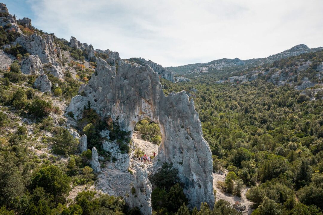 Rocky hike trail along Sardinia’s east coast cliffs and pine forest valleys