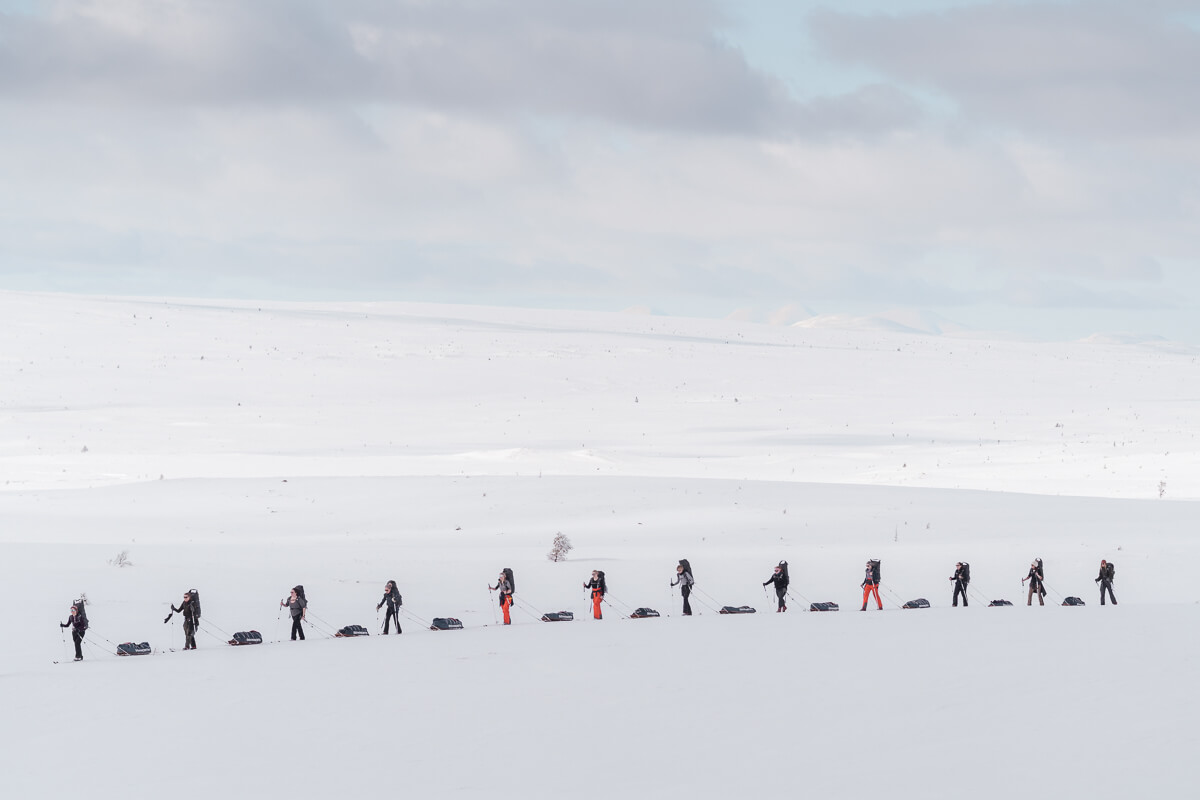 Backcountry skiers trekking across a snowy landscape in winter