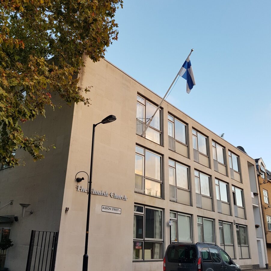 Flag on a building exterior on Albion Street, UK, with windows and street lamps.