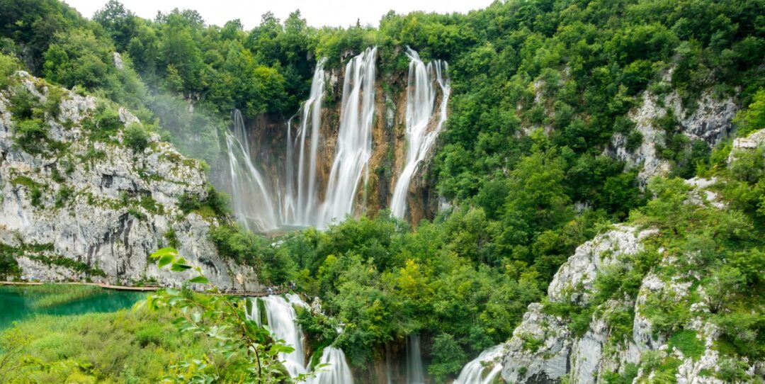 Waterfall cascade in a lush green landscape, likely Croatia—ideal for a paddleboarding trip near Zadar.