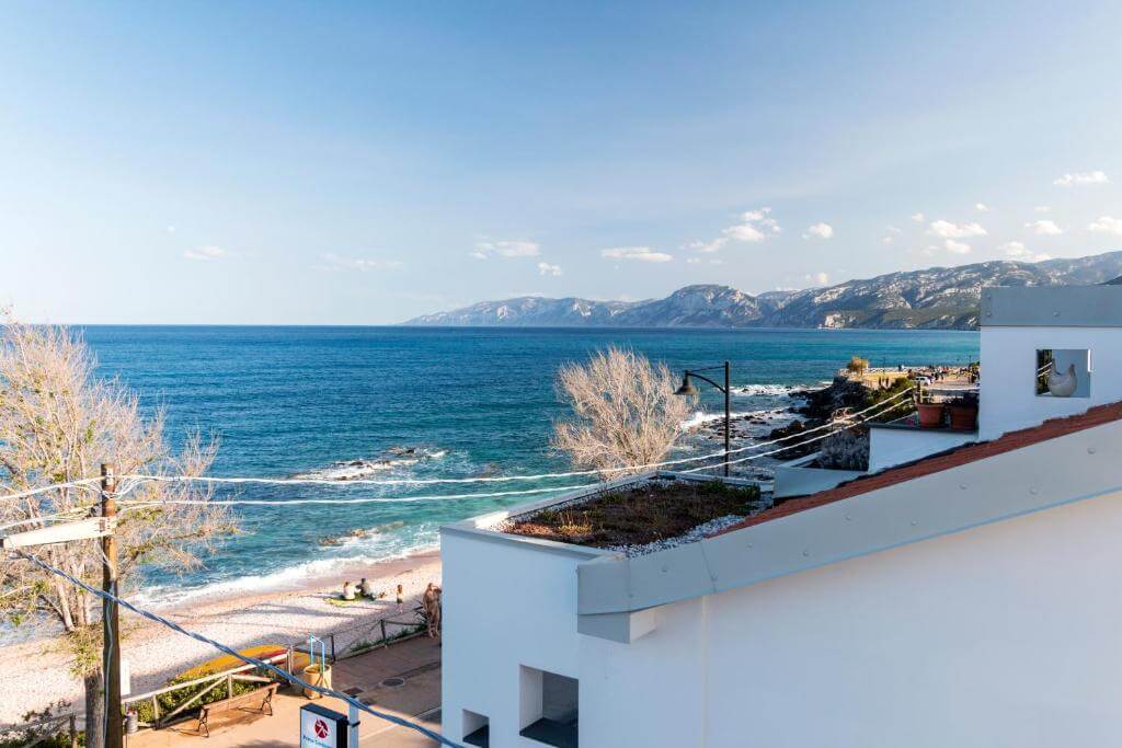 Coastal sea view from a hillside home on Sardinia’s east coast, with blue waters and distant mountains