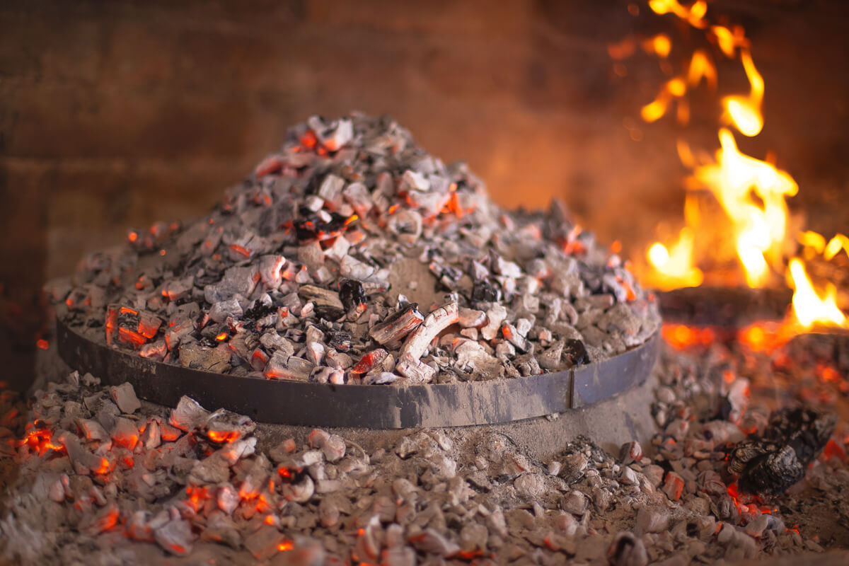 Burning campfire in a fire pit with glowing embers and flames