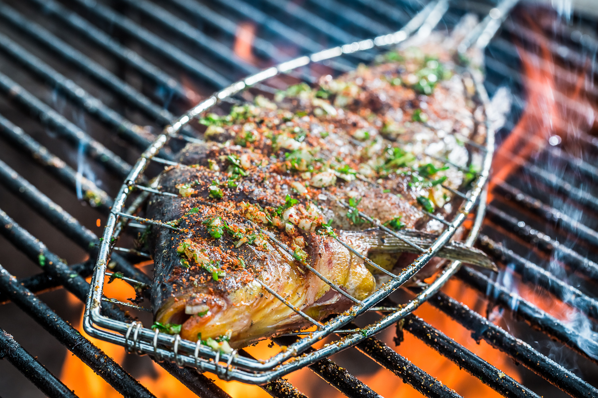 Grilled fish on a barbecue grill, Sardinia SUP hike and yoga weekend food highlight