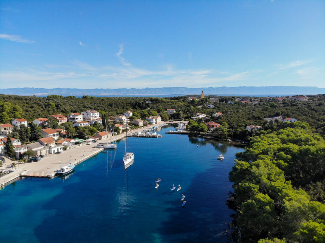 Kayaks on a calm Adriatic harbour near a coastal town in Croatia