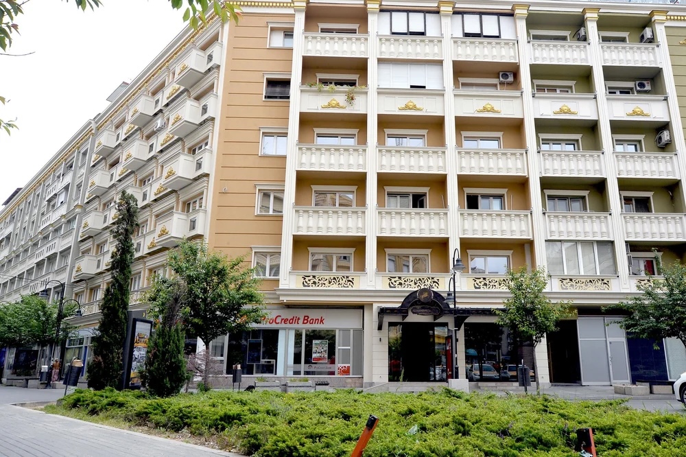 ProCredit Bank storefront on a street-front apartment building in North Macedonia (urban street view).