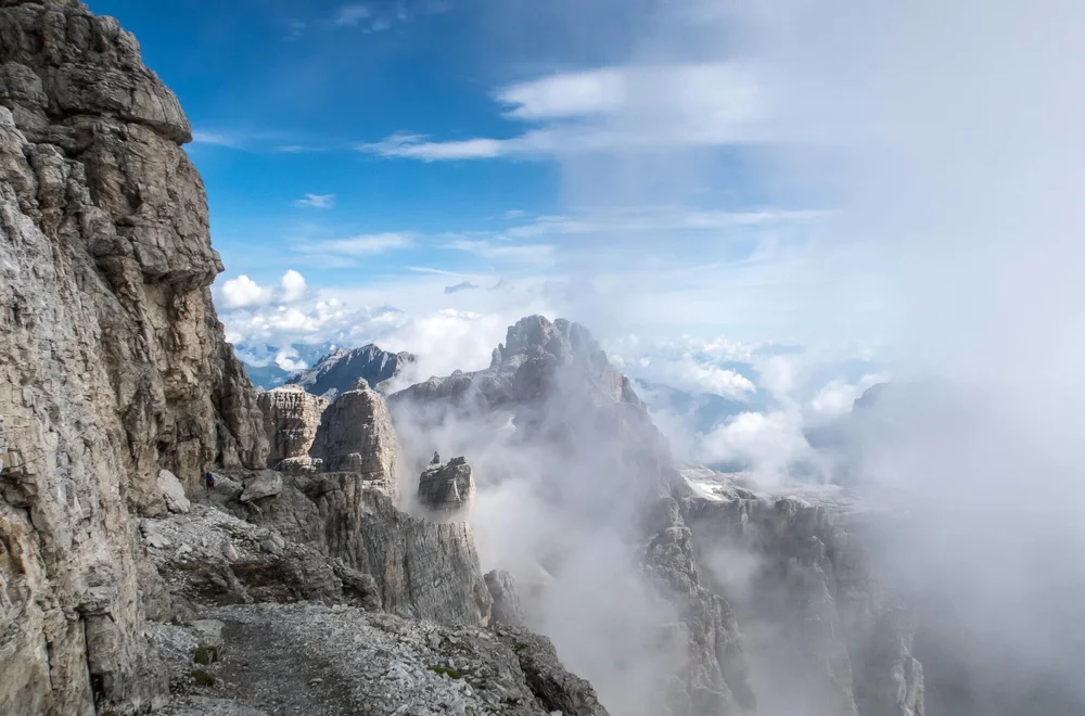Rocky mountain ridge with clouds, Dolomites—view from a via ferrata route