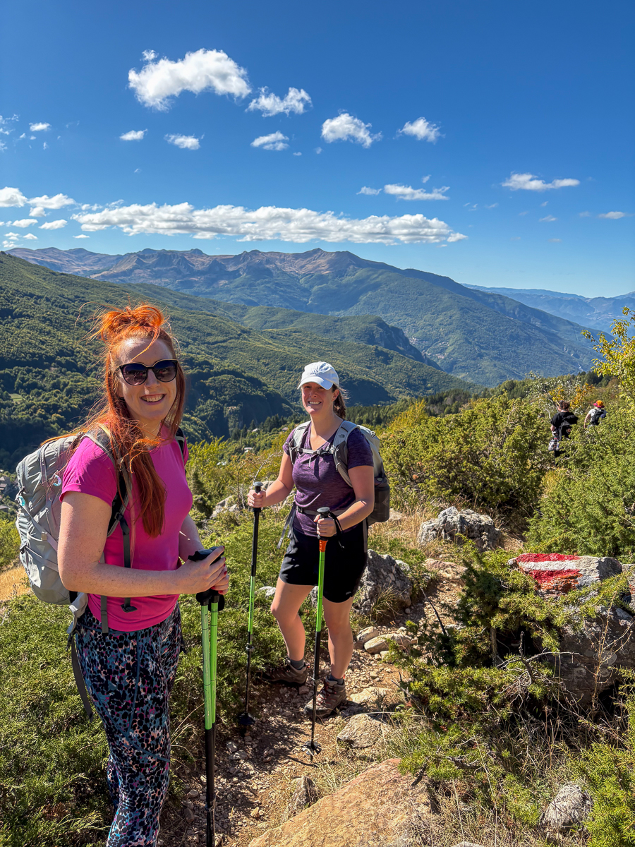 Women hiking on a mountain trail with sweeping valley views in North Macedonia