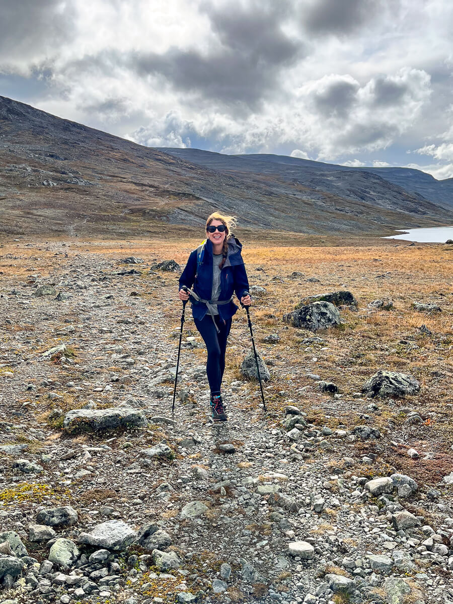 Woman hiking on a rocky trail in Norway’s mountains under cloudy skies, beginner-friendly hike scenery