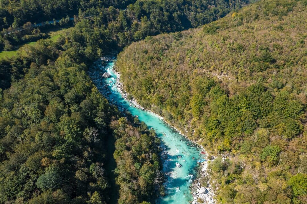 Turquoise river winding through forested hills in Croatia, Slovenia and Italy adventure holiday scenery