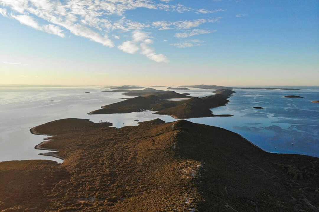 Aerial view of coastal islands and clear sea at sunset