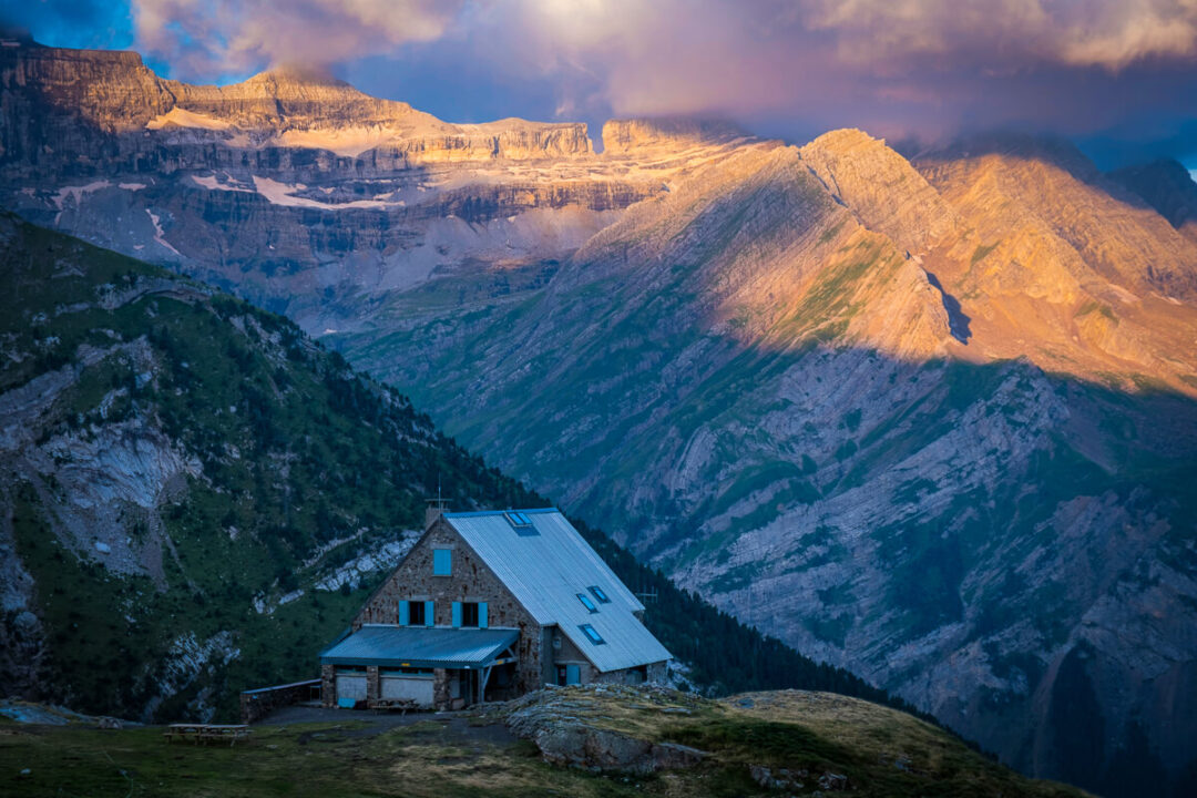 Women’s hut at dusk with mountain landscape in the Spanish Pyrenees, overlooking valleys and peaks