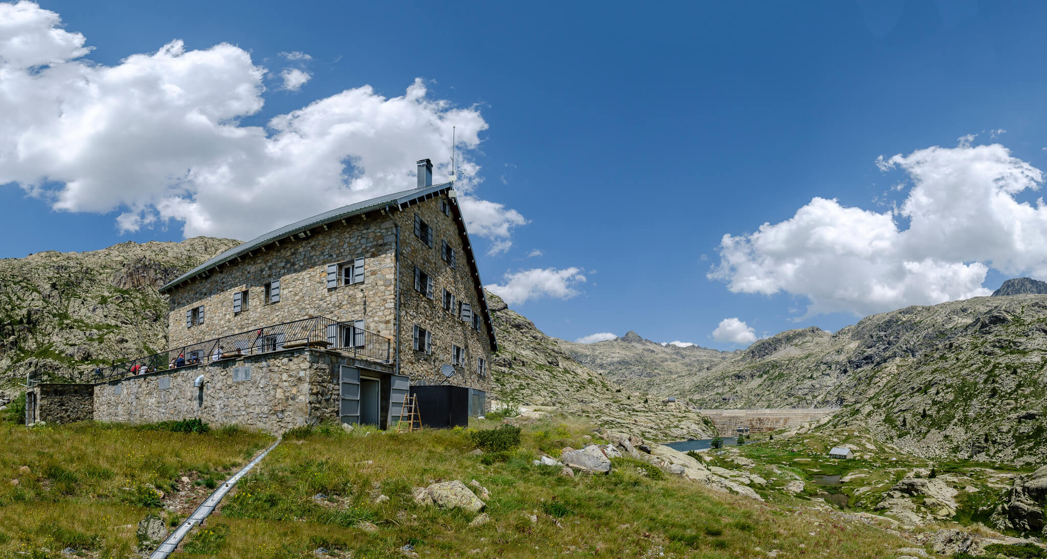 Stone mountain hut in the Spanish Pyrenees, set beside a hiking path with rugged valley views