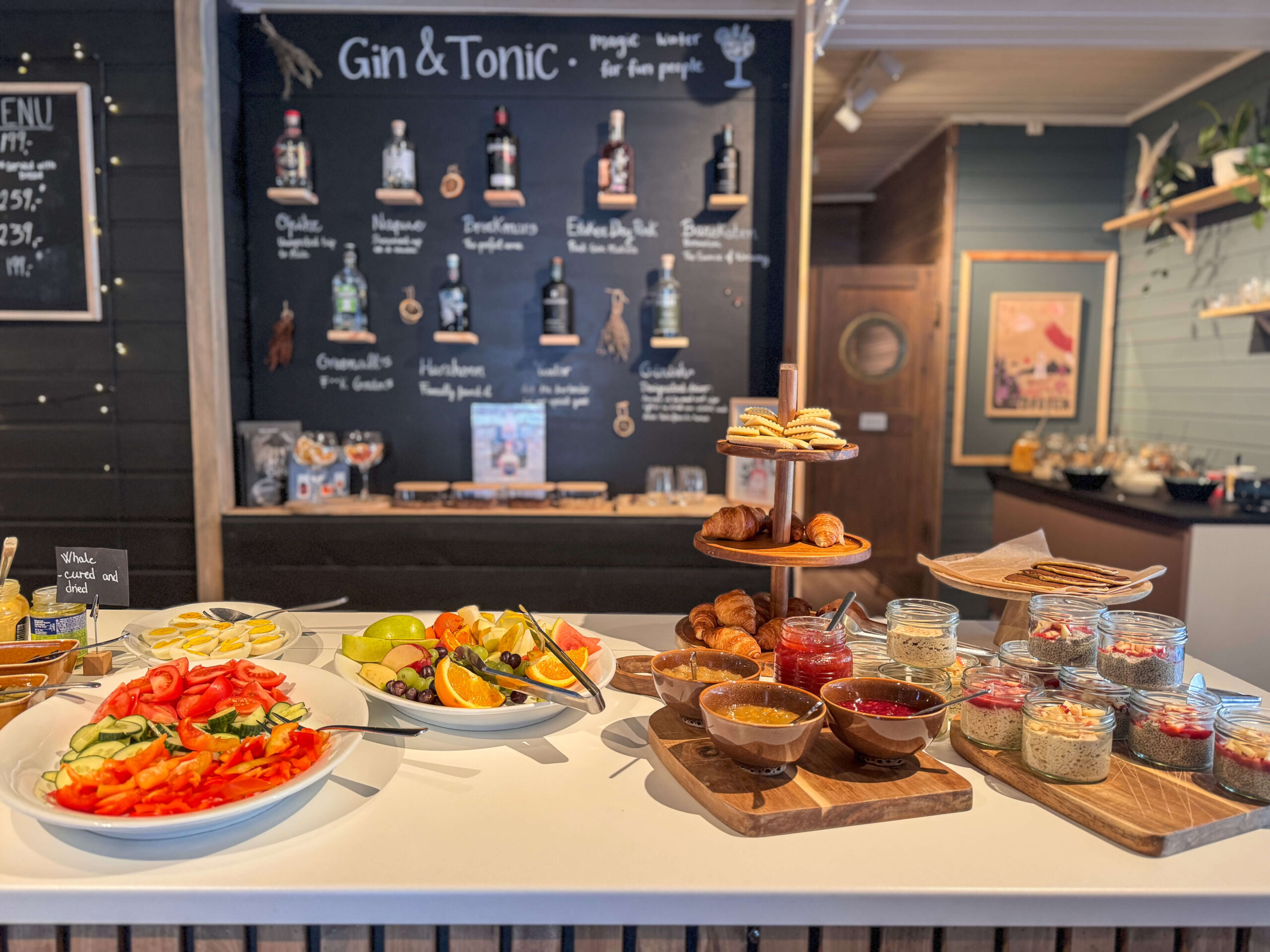 Gin & Tonic chalkboard menu and buffet snacks on a table at a bar