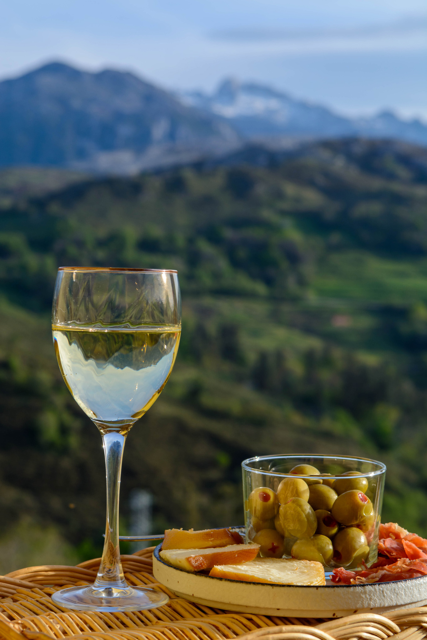 Wine and tapas on a hut terrace with a mountain view over the Spanish Pyrenees valley