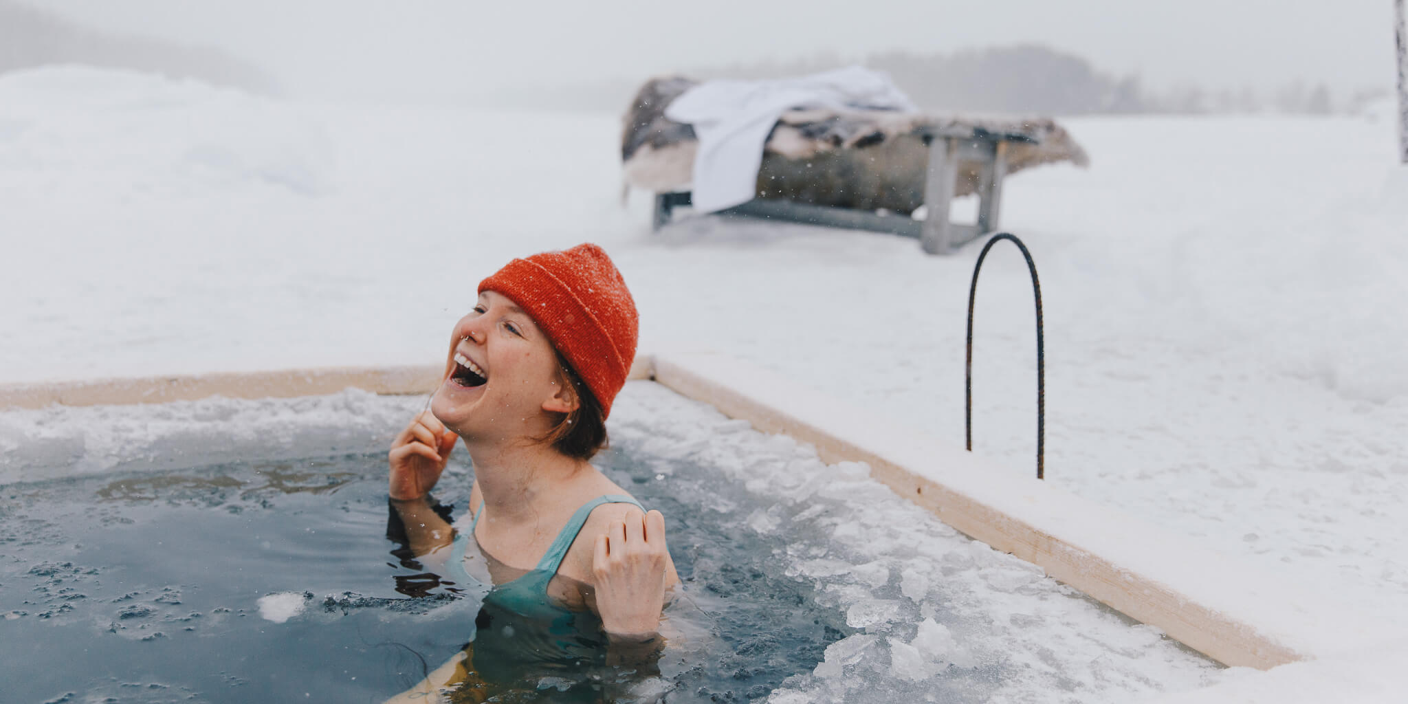 Woman relaxing in an outdoor hot tub in snowy Lapland during winter