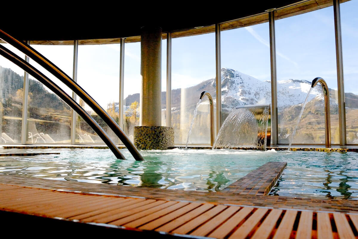 Indoor pool with steam and mountain views, suitable for winter hiking in the Pyrenees