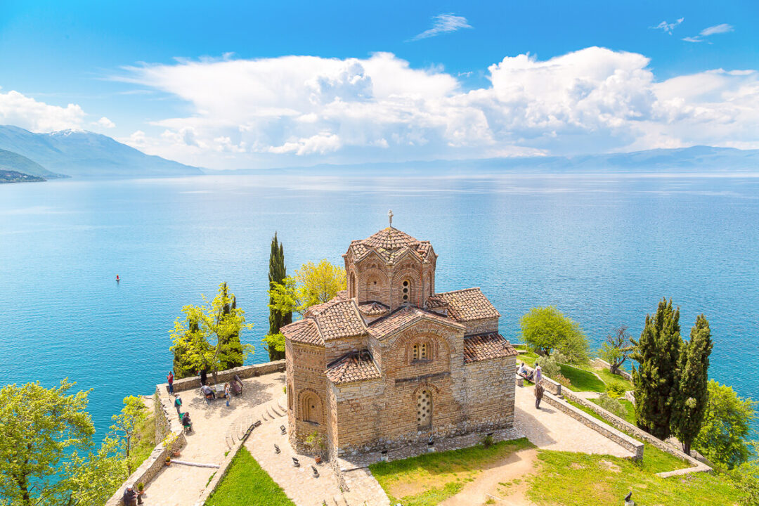 St John at Kaneo church overlooking Lake Ohrid, North Macedonia, with blue lake and mountains in the distance