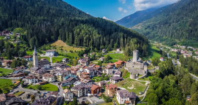 Aerial view of a village in the Dolomites, Italy, surrounded by mountains and forests
