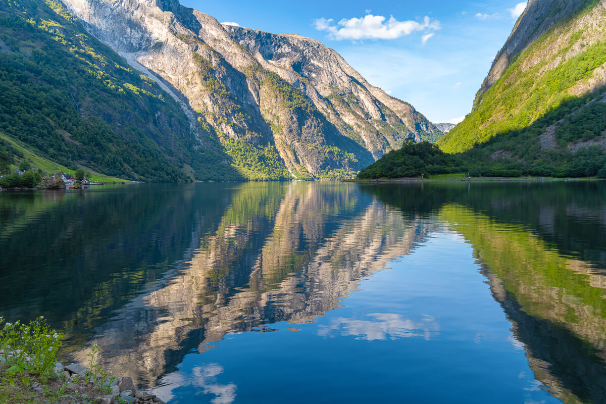 Mountain fjord in Jotunheimen National Park, Norway, with calm water reflections and valley slopes