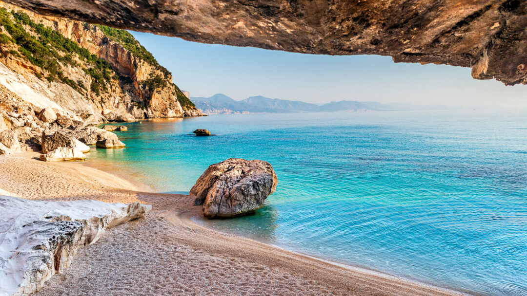 Rocky beach on Sardinia’s east coast with turquoise sea and coastal cliffs