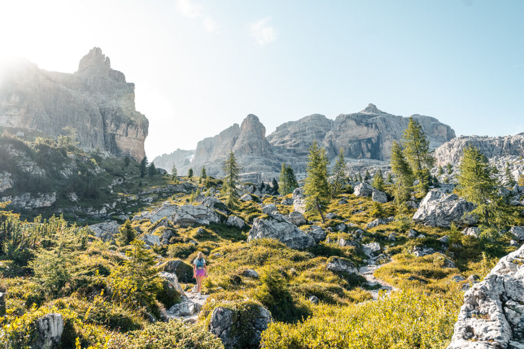 Hiking through the Dolomites, Italy, amid rocky peaks and alpine meadows