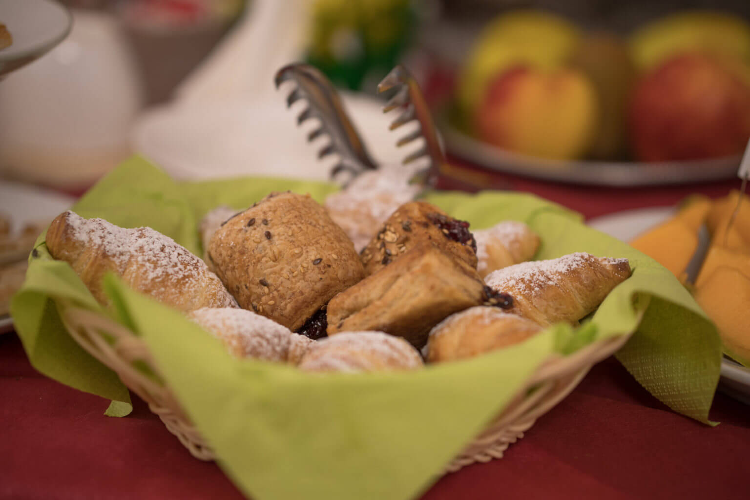 Basket of freshly baked bread rolls on a table, ready for an Italian hiking meal stop in Sardinia’s east coast