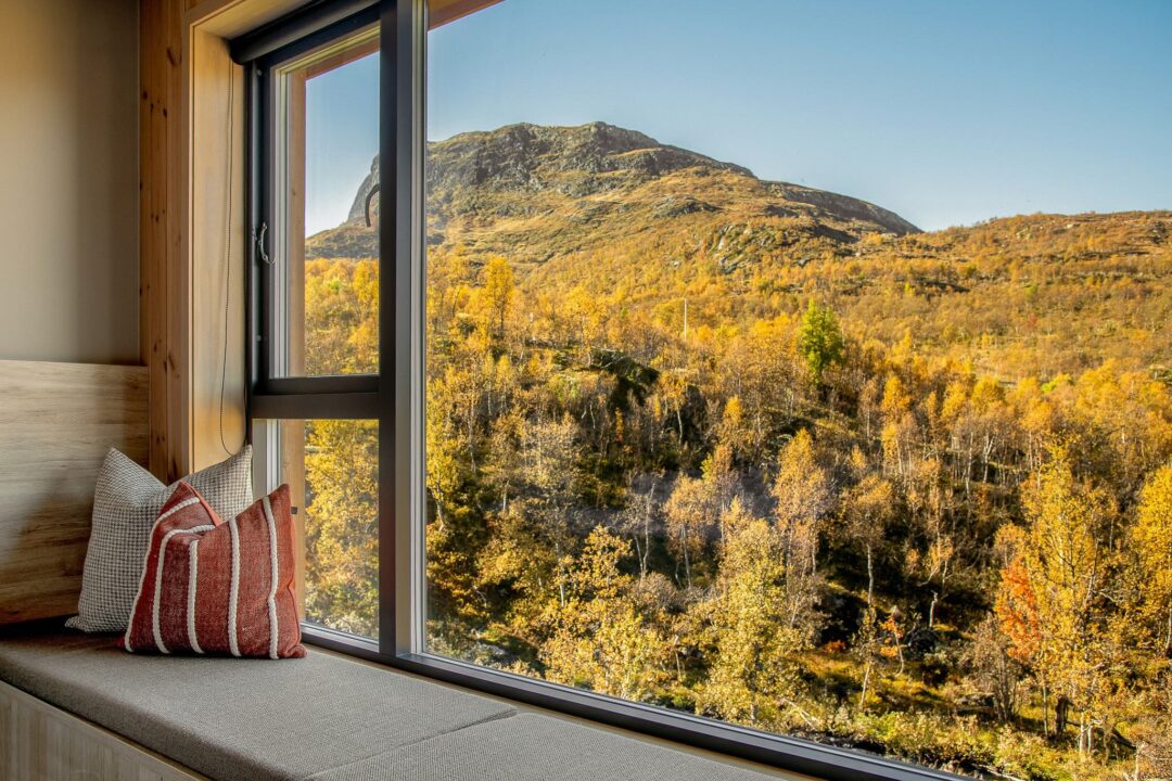View of autumn mountains and valley through a cabin window